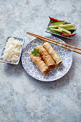 Image showing Orginal asian deep fried spring rolls placed on beautiful oriental style plate