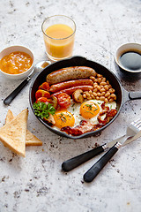 Image showing Full English breakfast on bright rusty background