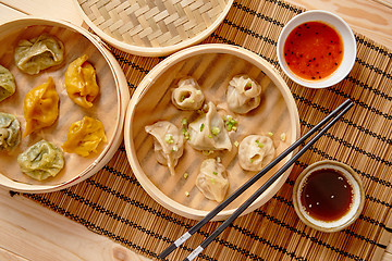 Image showing Oriental traditional chinese dumplings served in the wooden steamer