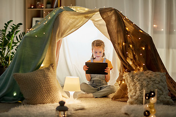 Image showing little girl with tablet pc in kids tent at home