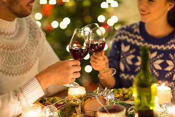 Image showing happy couple drinking red wine at christmas dinner