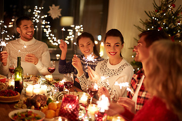 Image showing happy friends celebrating christmas at home feast