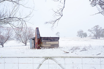 Image showing Ramshackle rustic shack in snowy rural scene