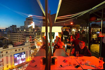 Image showing People enjoying evening drinks and amazing panoramic views of Madrid at dusk on rooftop bar of El Corte Ingles department store in Madrid, Spain.