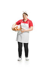 Image showing Portrait of cute smiling woman with pastries in her hands in the studio, isolated on white background