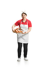 Image showing Portrait of cute smiling woman with pastries in her hands in the studio, isolated on white background