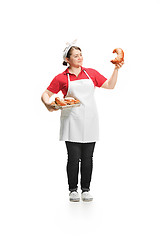 Image showing Portrait of cute smiling woman with pastries in her hands in the studio, isolated on white background