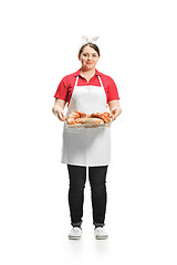 Image showing Portrait of cute smiling woman with pastries in her hands in the studio, isolated on white background