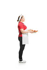 Image showing Portrait of cute smiling woman with pastries in her hands in the studio, isolated on white background