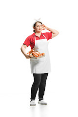 Image showing Portrait of cute smiling woman with pastries in her hands in the studio, isolated on white background