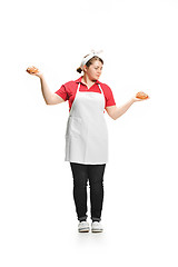 Image showing Portrait of cute smiling woman with pastries in her hands in the studio, isolated on white background