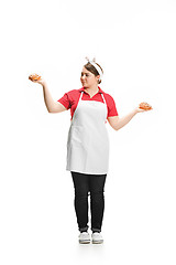 Image showing Portrait of cute smiling woman with pastries in her hands in the studio, isolated on white background