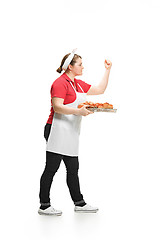 Image showing Portrait of cute smiling woman with pastries in her hands in the studio, isolated on white background