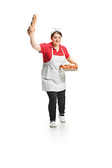 Image showing Portrait of cute smiling woman with pastries in her hands in the studio, isolated on white background