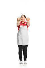 Image showing Portrait of cute smiling woman with pastries in her hands in the studio, isolated on white background