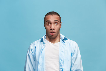 Image showing The young attractive man looking suprised isolated on blue