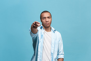 Image showing The overbearing businessman point you and want you, half length closeup portrait on blue background.