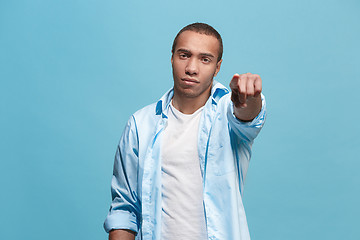 Image showing The overbearing businessman point you and want you, half length closeup portrait on blue background.