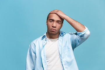 Image showing Man having headache. Isolated over blue background.