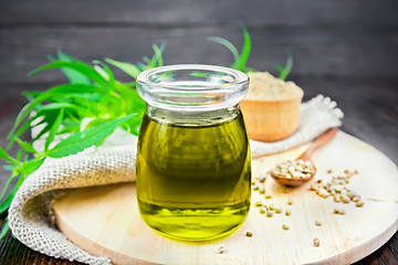 Image showing Oil hemp in jar with burlap on board