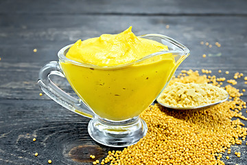 Image showing Sauce mustard in sauceboat with powder on black board