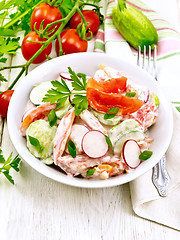 Image showing Salad from fresh vegetables in plate on light board