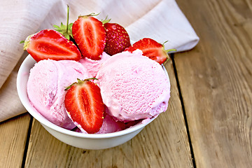 Image showing Ice cream strawberry in bowl on wooden board