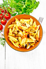 Image showing Pasta penne with eggplant and tomatoes on board top