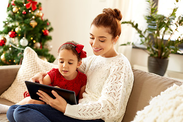 Image showing mother and daughter with tablet pc on christmas