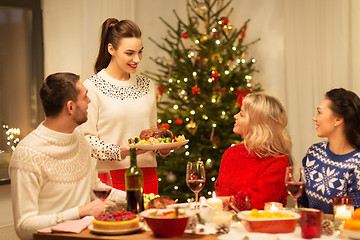 Image showing happy friends having christmas dinner at home