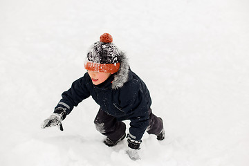 Image showing happy little boy in winter clothes outdoors