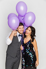 Image showing happy couple with ultra violet balloons at party