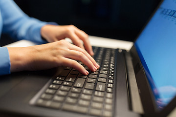 Image showing close up of female hands with laptop typing