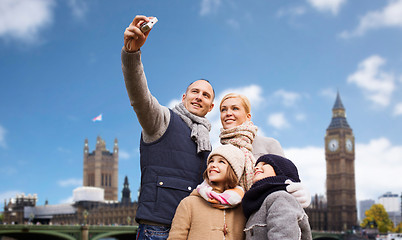 Image showing family taking selfie by camera over london city