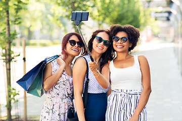 Image showing women with shopping bags taking selfie outdoors