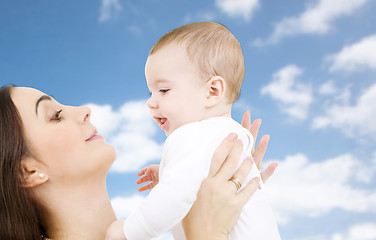 Image showing mother with baby over sky background