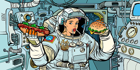 Image showing Woman astronaut eats in a spaceship