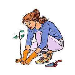 Image showing woman working in the garden, planting a seedling