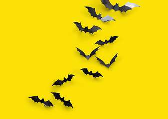 Image showing black halloween bats on yellow background