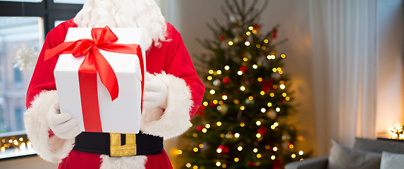 Image showing santa claus with christmas gift over room