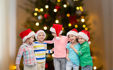 Image showing happy children over christmas tree lights