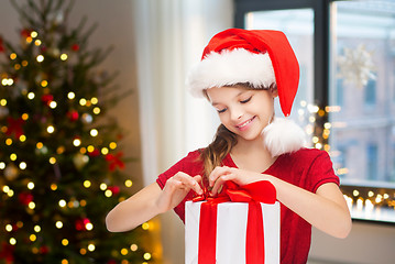 Image showing happy girl with christmas gift at home