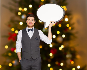 Image showing man holding blank text bubble over christmas tree