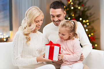 Image showing happy family at home with christmas gift