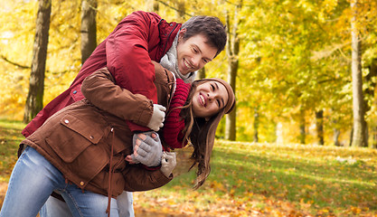 Image showing happy young couple having fun in autumn park