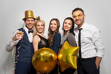 Image showing happy friends with golden party props posing
