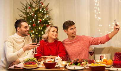 Image showing friends taking selfie at christmas dinner