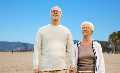 Image showing happy senior couple over venice beach background