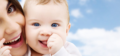 Image showing mother with baby over sky background