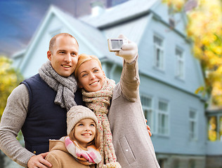 Image showing family takes autumn selfie by cellphone over house